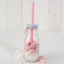 Botellita cristal con caña rosa y viruta blanca con 12 caramelos como detalle para invitados de comunión